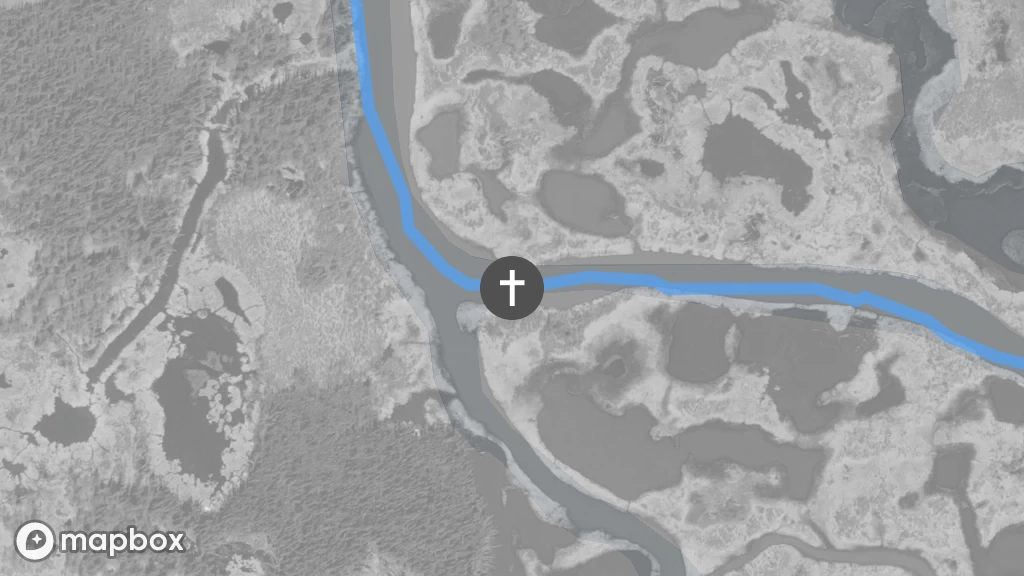 A satellite image of a gravesite located on the north shore of the Lac La Martre River, directly above where the a small island.