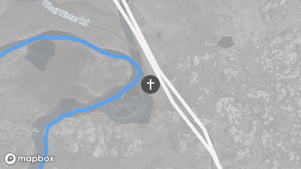 A satellite image of a gravesite located on the shore east of the Marian River, next to the winter roads that connect Behchokǫ̀ and Gamètı̀.